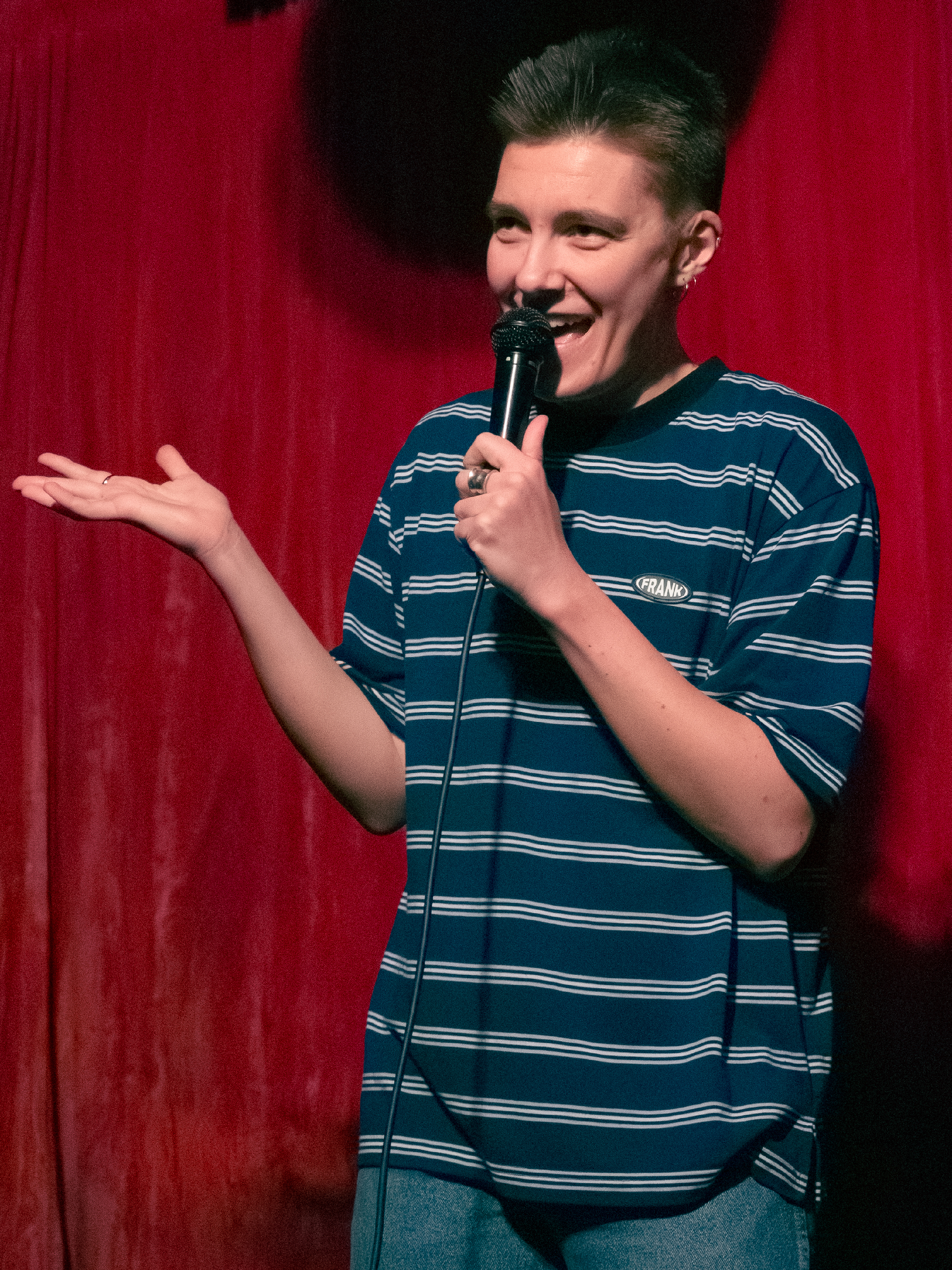 Kendall Allison tells joke with their hands.