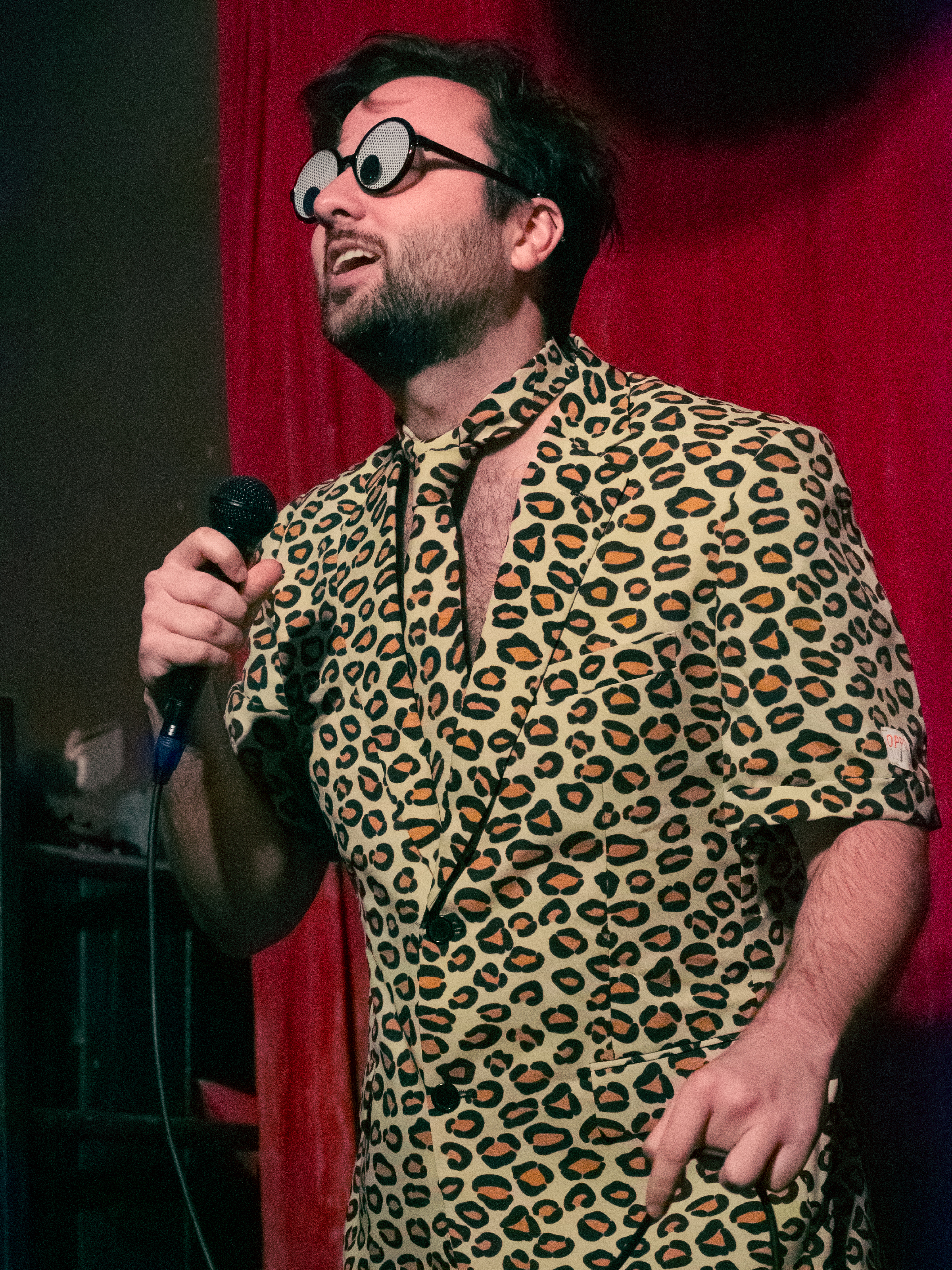 Madoc Smith brought a prop! He looks at audience through googly-eye glasses he absolutely cannot actually see in.