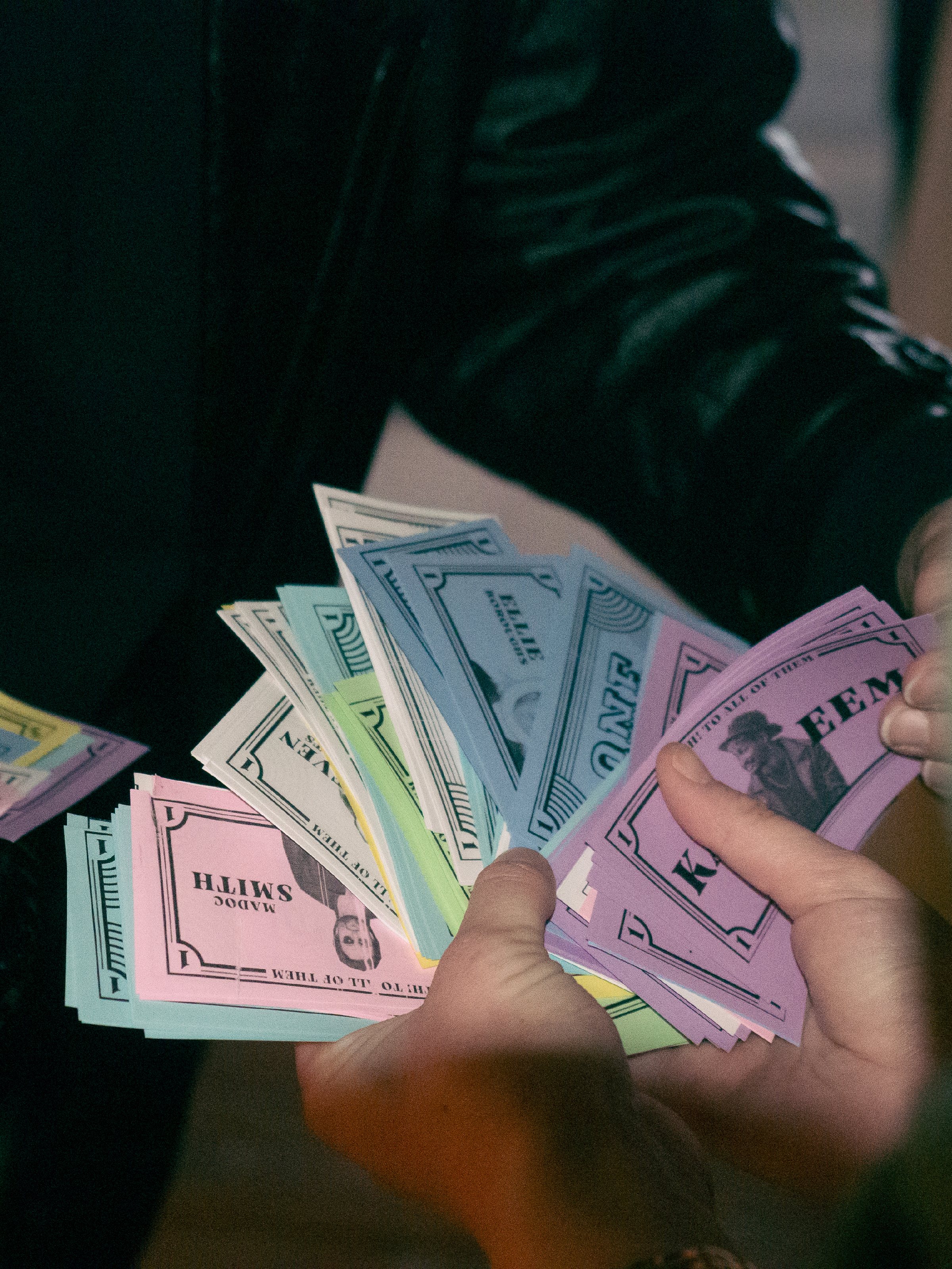 Prop money is passed from host to comedian.