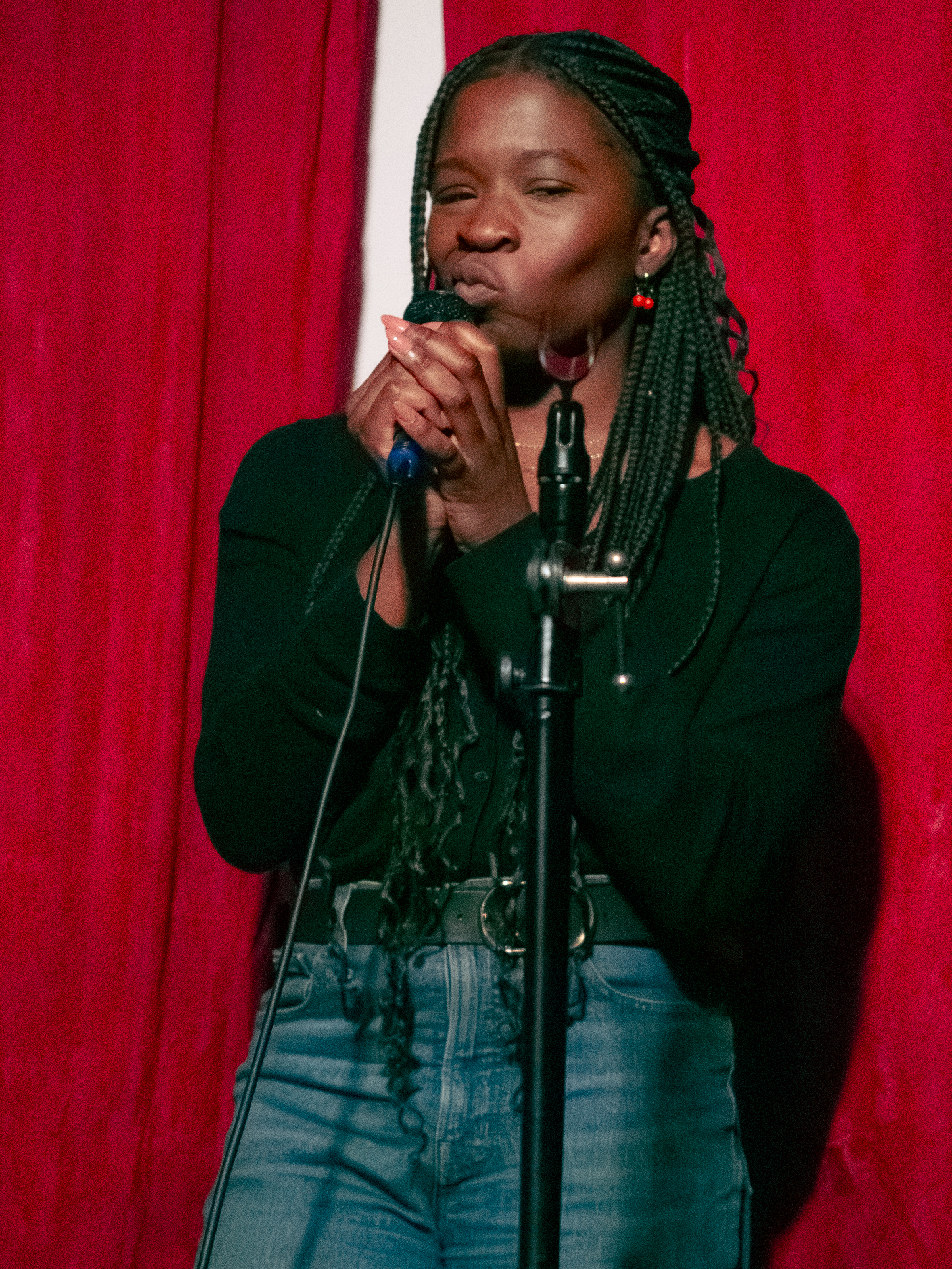 Temi Adeoye smirks during a pause for laughs.