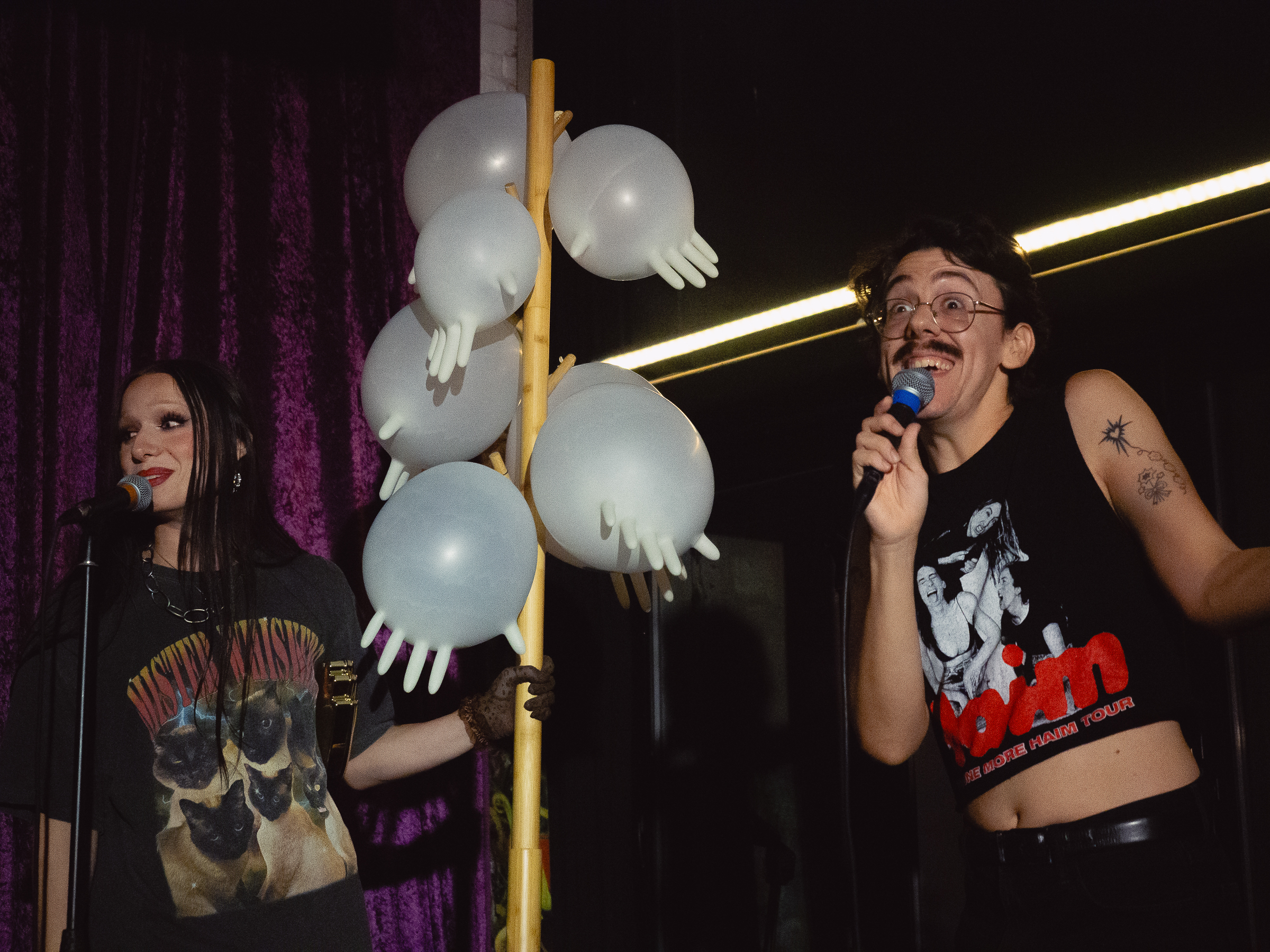 Host, Tina Hand, on stage with Erik Martini.